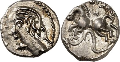 a silver coin with an image of a horse on it
