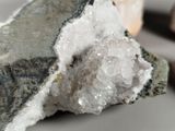 a piece of rock that has some white crystals on it