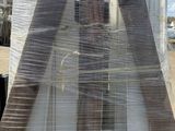 a picture of a large wooden triangle with plastic wrap around it