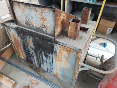 a rusted metal cabinet in the middle of a garage