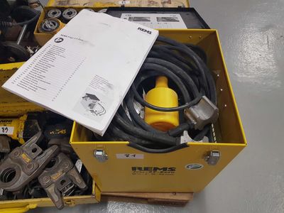 a box of tools sitting on the floor next to a yellow box