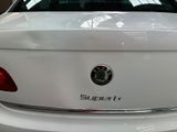 the back end of a white car with a supertech logo on it