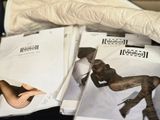 a lot of magazines that are laying on a bed