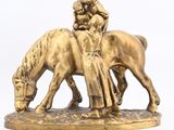 a statue of a man riding a horse with a woman on it