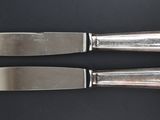 two knives that are sitting on top of a table