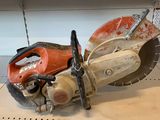 a red and white circular saw on a shelf