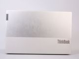 a white box with a silver lid sitting on a table