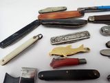many different types of knives on a white surface