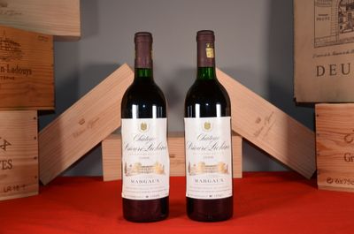 two bottles of wine sitting next to each other on a table