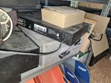 a stack of electronics sitting on top of a metal shelf