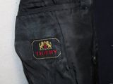 a black suit jacket with a red and gold logo on it