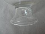 a glass bowl with a lid on a white surface