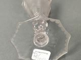 a clear glass candle holder with a label on it