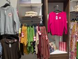 a lot of clothes that are on display in a store