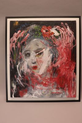 painting of a woman ' s face with red hair in a black frame