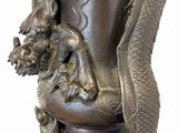 a statue of a dragon with a crown on it ' s head