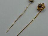 pair of gold plated hair pins with black stones on them