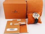an image of a watch sitting on top of a box next to a pillow
