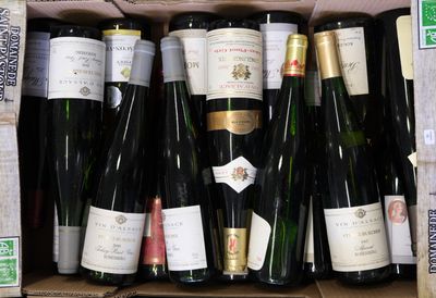 many bottles of wine in a box on the table