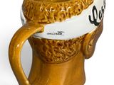 a brown mug with a white band around it