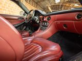 the interior of a car with red leather seats and a steering wheel
