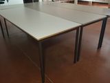 two ping pong tables in the middle of a room
