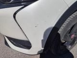 a close up of a car ' s front bumper with a denting on it