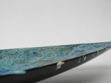 close up of a blue and black surfboard on a white surface