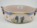 a large blue and white bowl with a painting on it