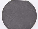 a black plate on a stand on a white surface