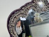 a mirror that is sitting on a desk in a room