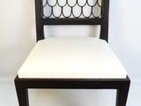 the back of a black and white chair with a scallop back