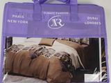 the purple bag has a picture of a bed and pillows on it