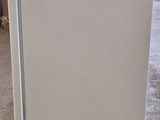 an image of a white refrigerator in a warehouse