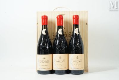 three bottles of wine in a wooden box on a white surface