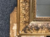 a picture of a gold framed mirror on the wall
