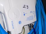 a blue hose attached to a white wall mounted water heater