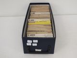 a black box filled with lots of books on a white surface