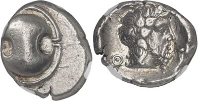 a close up of a silver coin with a face on it