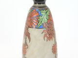 a vase with a floral design on it on a white surface