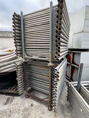a pile of metal pipes stacked on top of each other