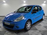the small blue car is parked in a large room
