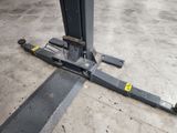 a close up of a fork lift in a warehouse