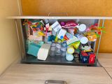 a metal trash can with many items inside of it