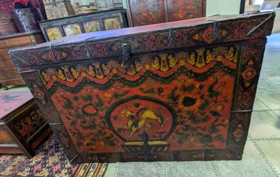 a chest with a design on it in the middle of a room
