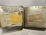 two old envelopes in a clear case on a table