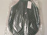 a plastic bag that has a green polka dot design on it