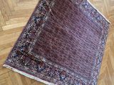 rug on the floor of a room with a wooden floor