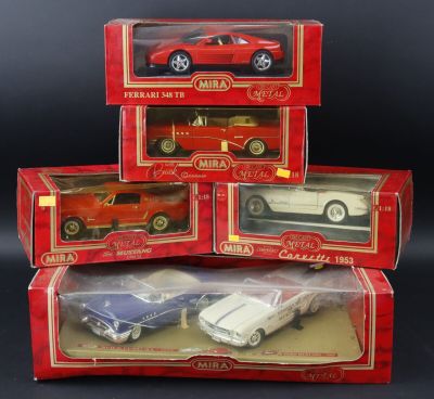 three boxed red and white toy cars in boxes on a black background