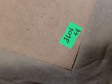 a box with a green sticker on it sitting on a table